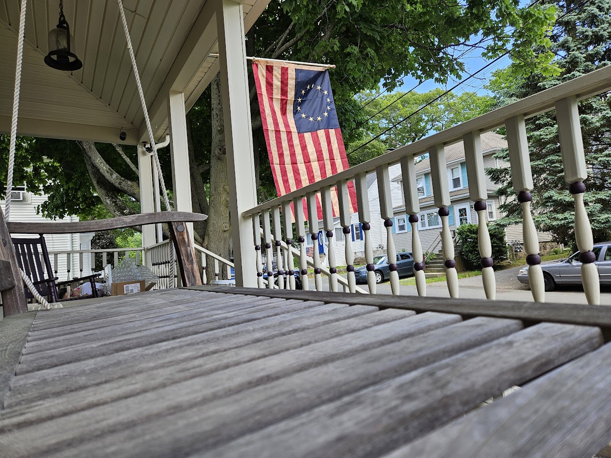 Professionally painted home exterior in Holbrook, MA with an American Flag