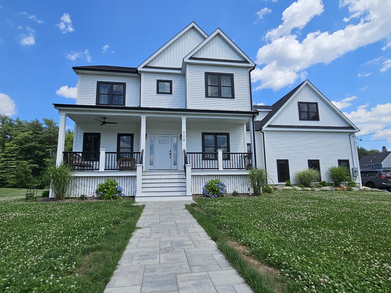 Front view of a beautifully painted farmhouse exterior in Holbrook, MA